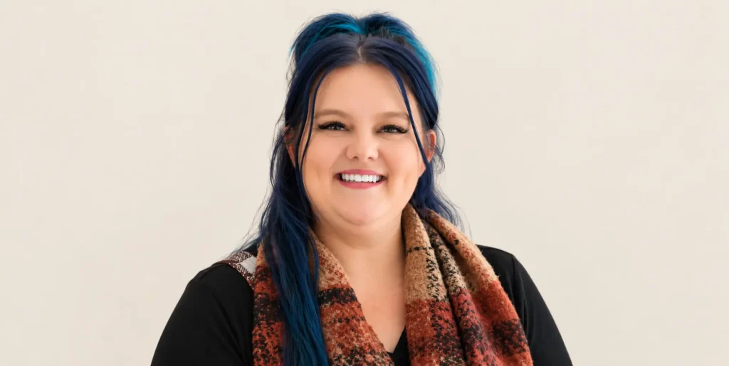 Photo of Vitale Team member Keeleigh, standing against beige backdrop