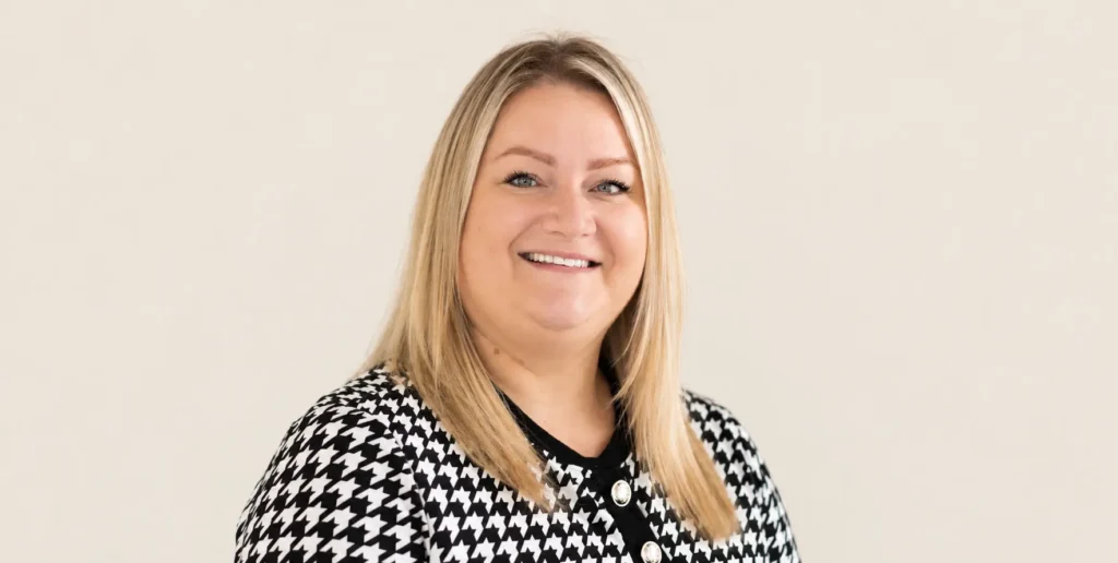 Photo of Vitale Team member Nicola, standing against beige backdrop