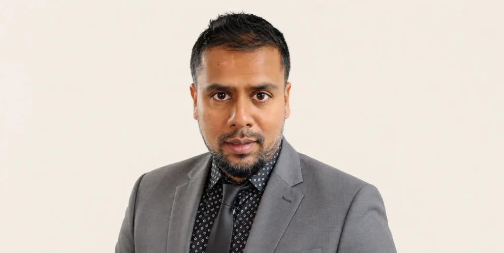 Photo of Vitale Team member Samad, standing against beige backdrop